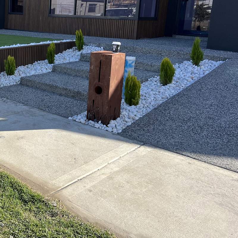 Exposed aggregate steps beside a corten letterbox