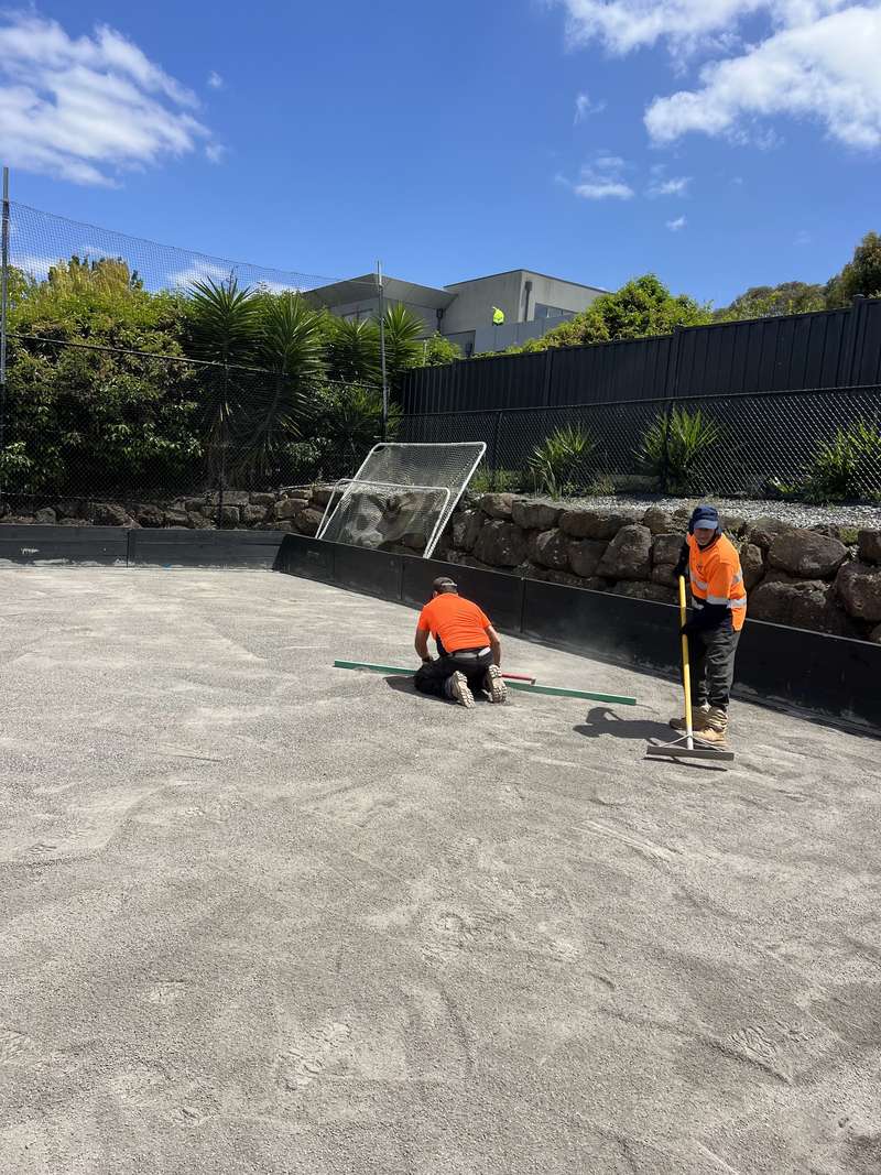 The crew screeding the crushed rock base before turf