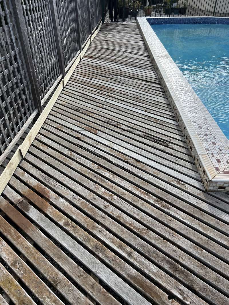 The old weathered timber deck boards before removal
